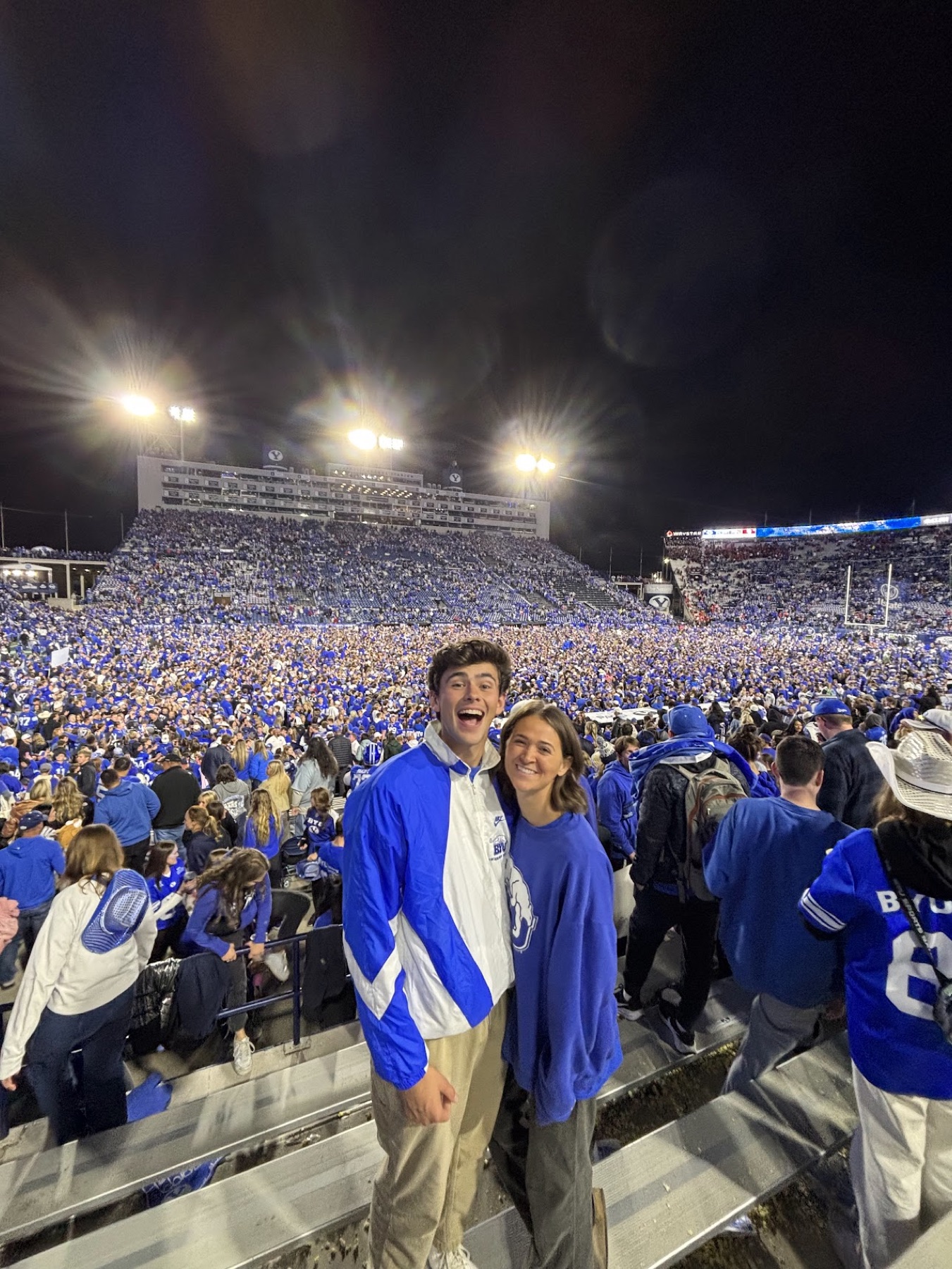 Jacob and his wife smiling together at a BYU football game